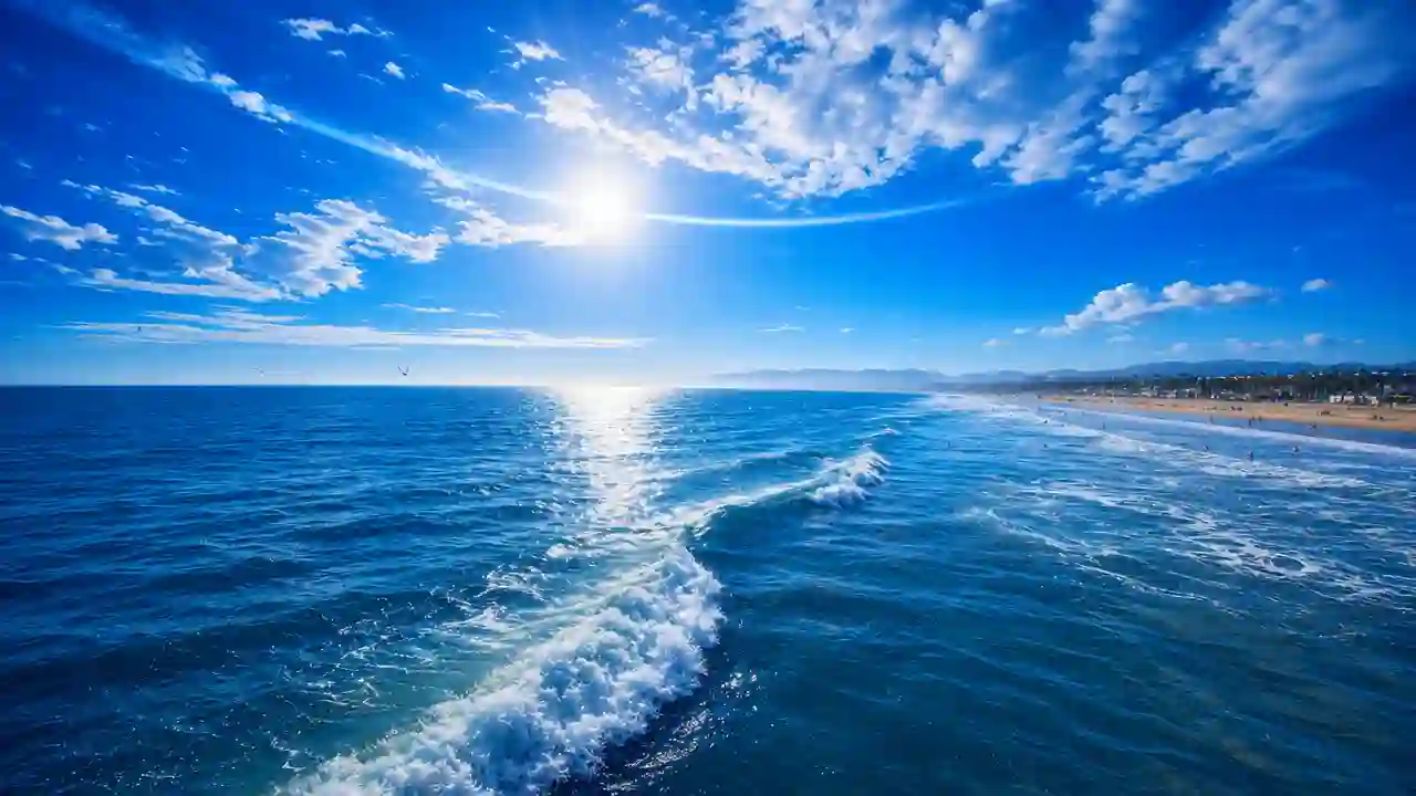 Bright sunlight over rolling ocean waves under a blue sky